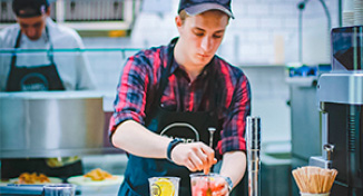 Image of Cafe worker making drinks